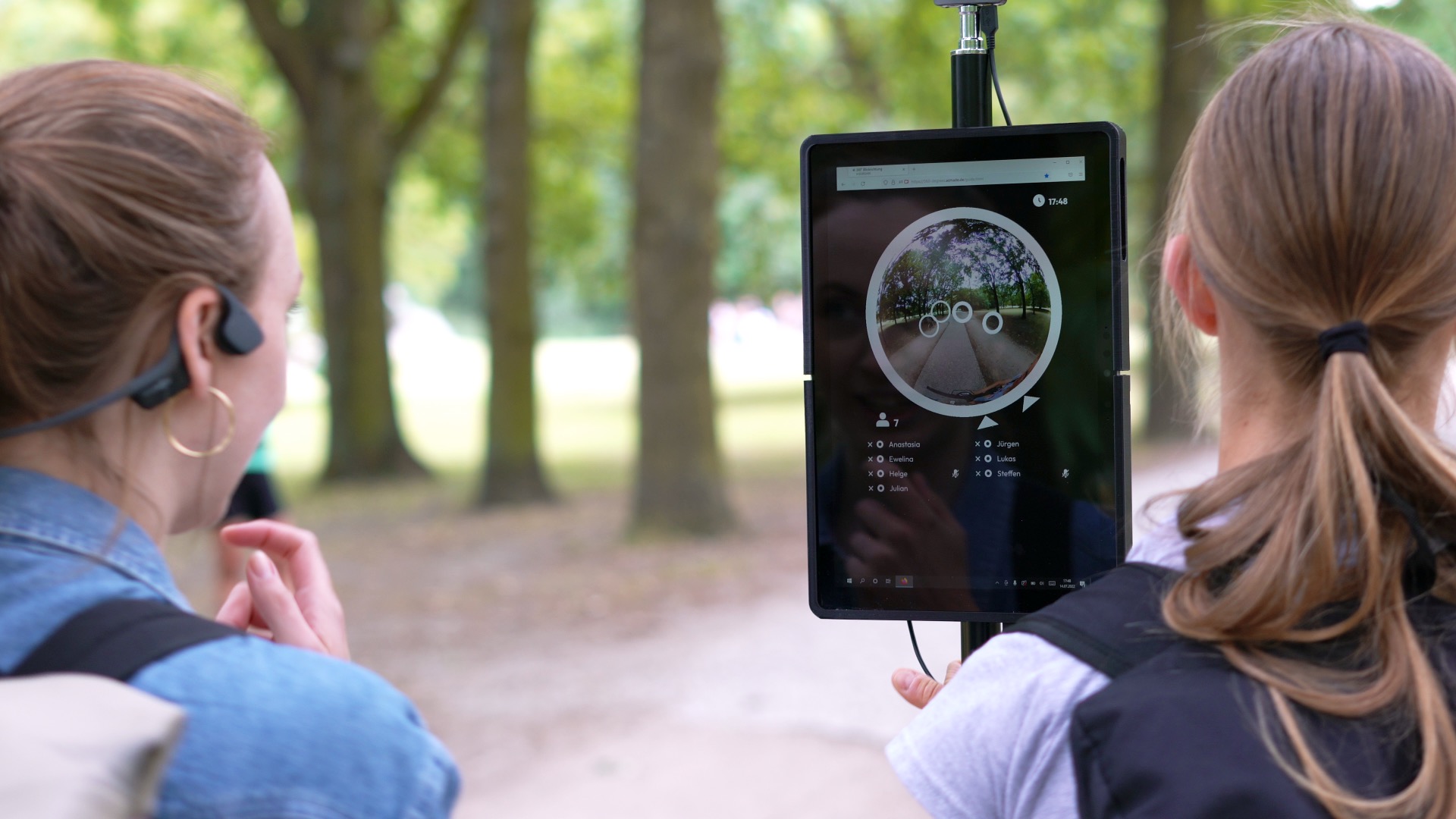 Museum guide leading a hybrid tour with remote participants